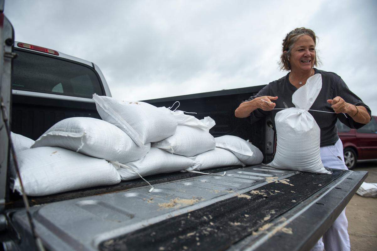 Beth Hatch, of Gulfport, fills sandbags in preparation for Hurricane Francine from a pile provided by Harrison County at the end of Courthouse Road in Gulfport on Tuesday.