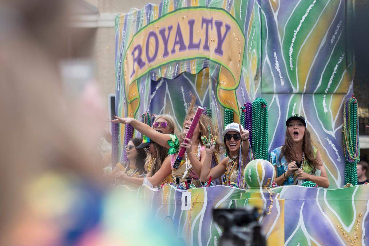 Members of GCCA royalty throw beads to the crowd during the Gulf Coast Carnival Association Mardi Gras parade in Biloxi on Tuesday, March 4, 2025.