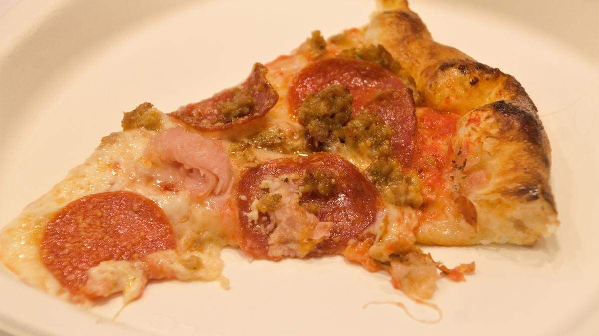 A delicious slice of the butcher pizza.