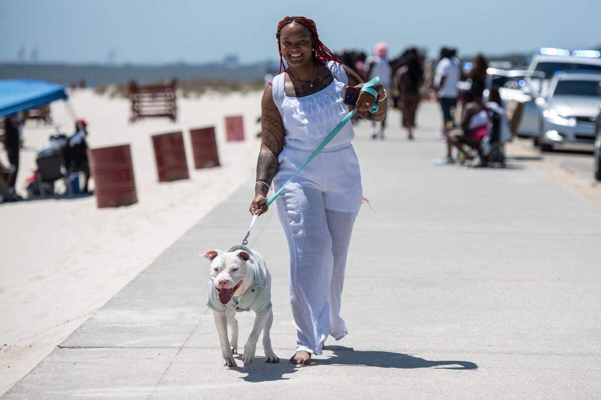 Jessica Cameron, of Tuscaloosa, Ala., walks her dog Diamond during Black Spring Break in Biloxi on Saturday, April 13, 2024