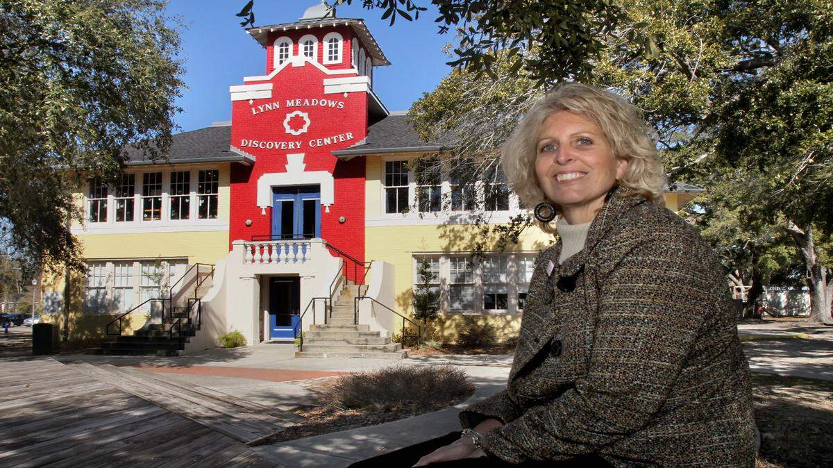 TIM ISBELL/SUN HERALD 
 Cindy DeFrances sits outside the Lynn Meadows Discovery Center in Gulfport. DeFrances is the new executive director of the center.