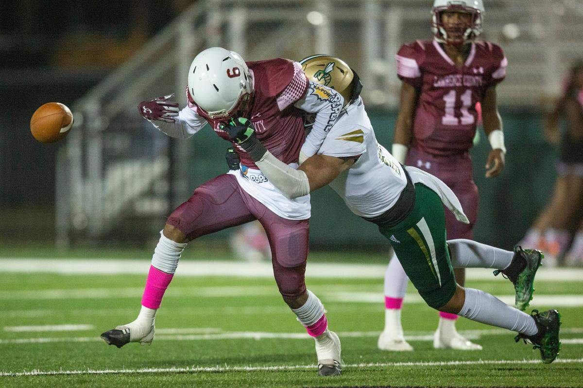 Poplarville’s Aden Dedeaux pulls on Lawrence County’s Wesley Harris’ facemask, causing him to drop the ball, during a game against Lawrence County at Poplarville High School in Poplarville on Friday, Oct. 7, 2022.