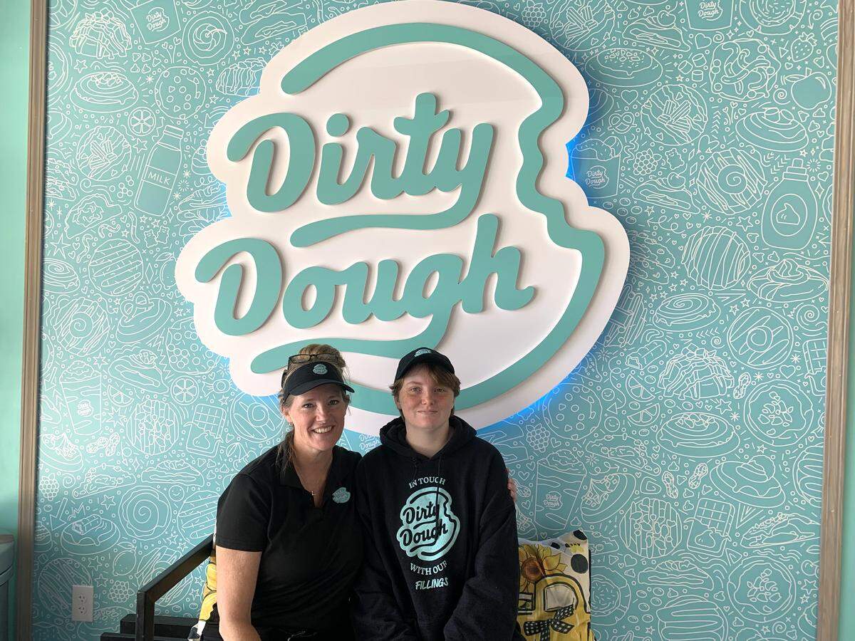 A social media bench just inside the door of the new Dirty Dough shop is a sweet spot for mother and daughter, Misty and Olivia Lusk, to grab a photo at their new business.