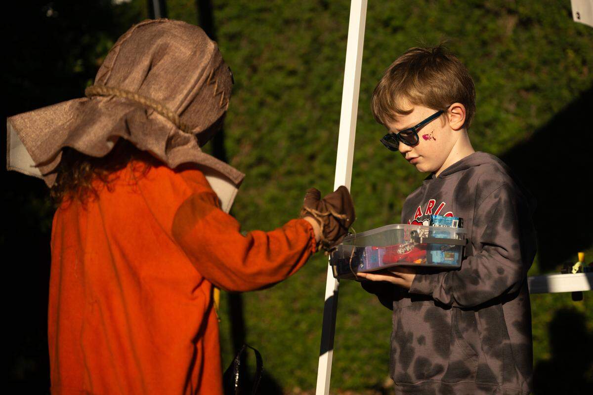 Candy is handed out on Rue Magnolia during Boo On The Rue in Biloxi on Thursday, October 30, 2025.