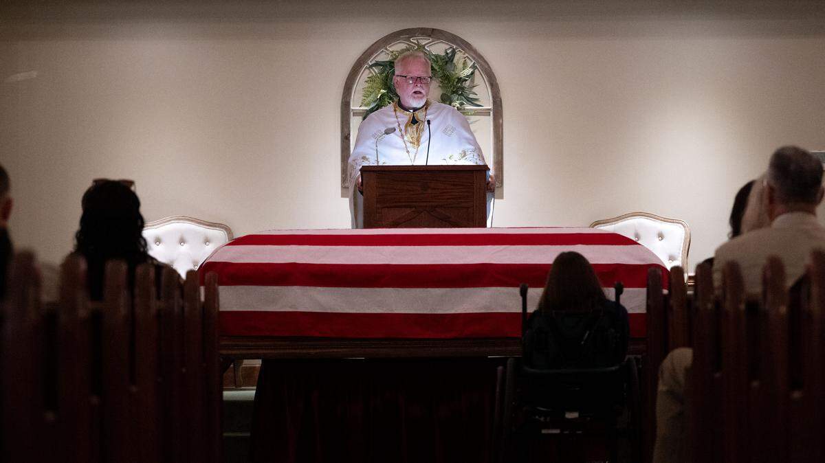Father Paisius McGrath speaks Wednesday during the funeral for Jackson County Sheriff’s Deputy Joshua Brashears.