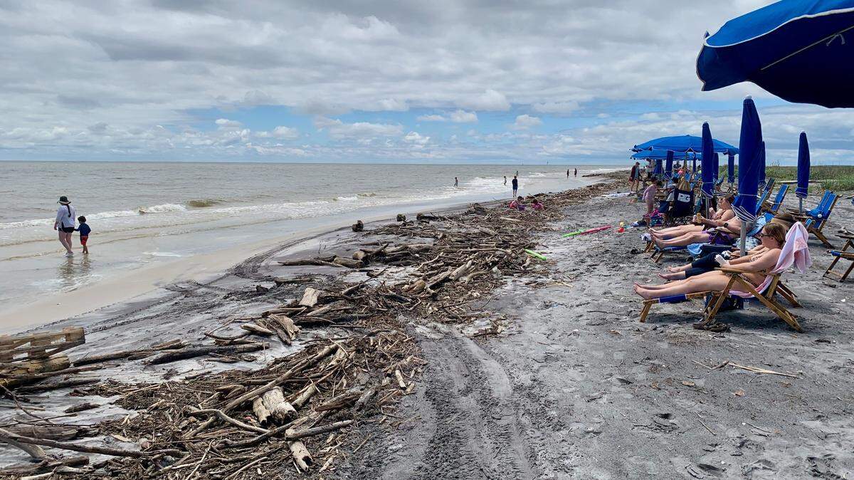 Beachgoers on Ship Island encounter debris washing up from flooding of the Mississippi River, which empties into the Gulf of Mexico. Ship Island Excursions is moving some beach chairs and umbrellas to the north side of the island, which remains in excellent shape, for those bothered by the debris line, a company representative said.