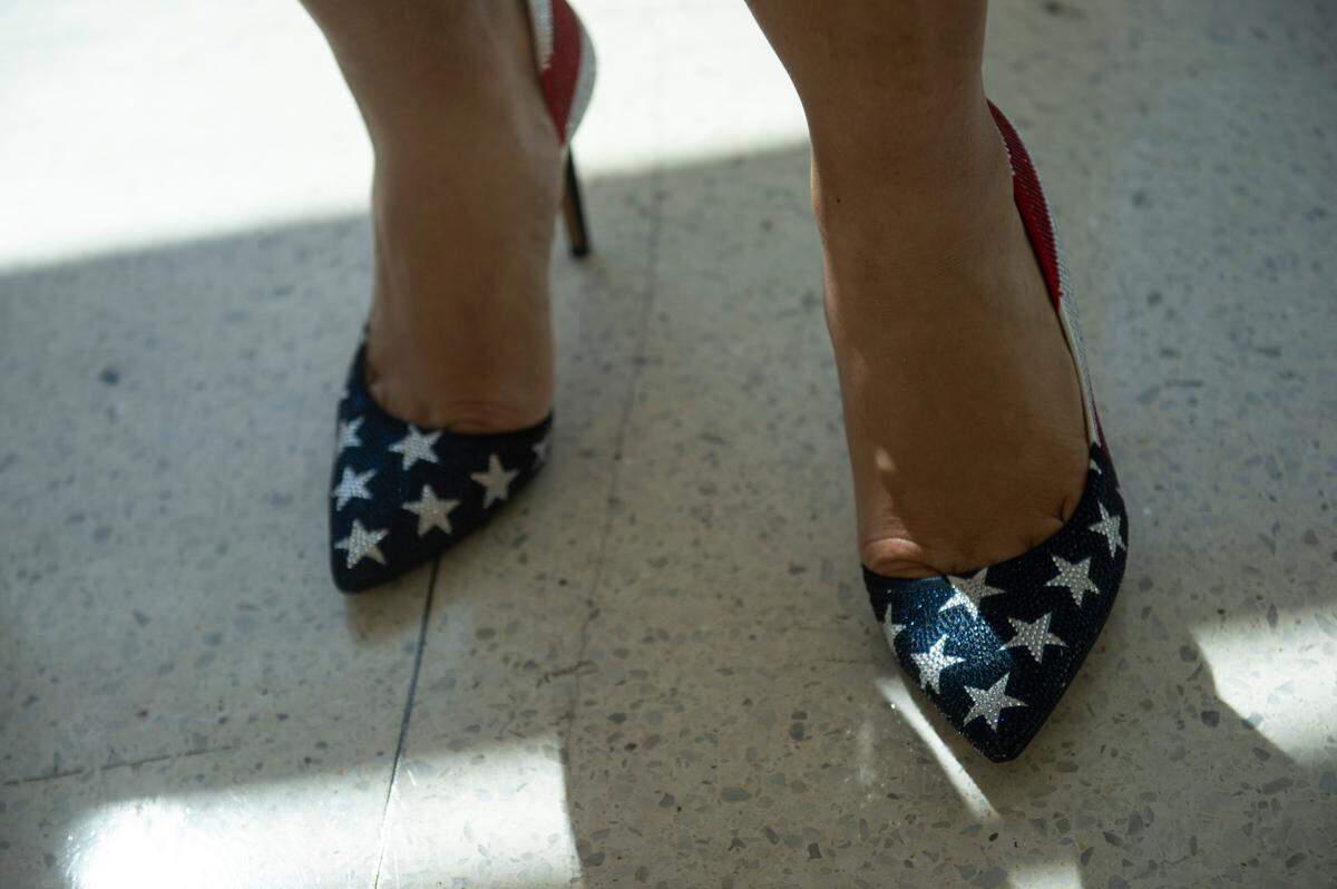 A woman wears American flag high heels after being confirmed as an American citizen at Dan M. Russell Jr. Federal Courthouse in Gulfport on Friday, Oct. 7, 2022.