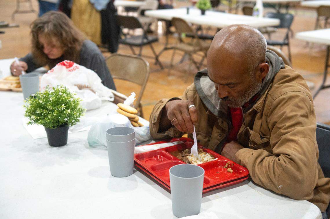 A man who identified himself as Ulysses eats a lunch provided by Loaves and Fishes at the former Mercy Cross High School gym in Biloxi on Tuesday, May 14, 2024. Catholic Social Services of South Mississippi is renovating the large building for a day center that will provide services to homeless people.