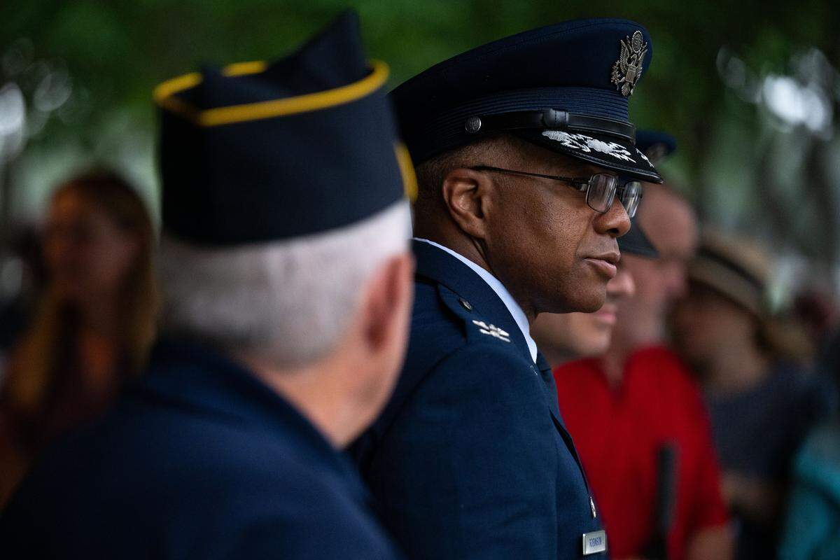Col. Christopher Robinson, right, turns to salute the flag for the playing of the national anthem during a ceremony at Biloxi National Cemetery on Monday, May 25, 2026.