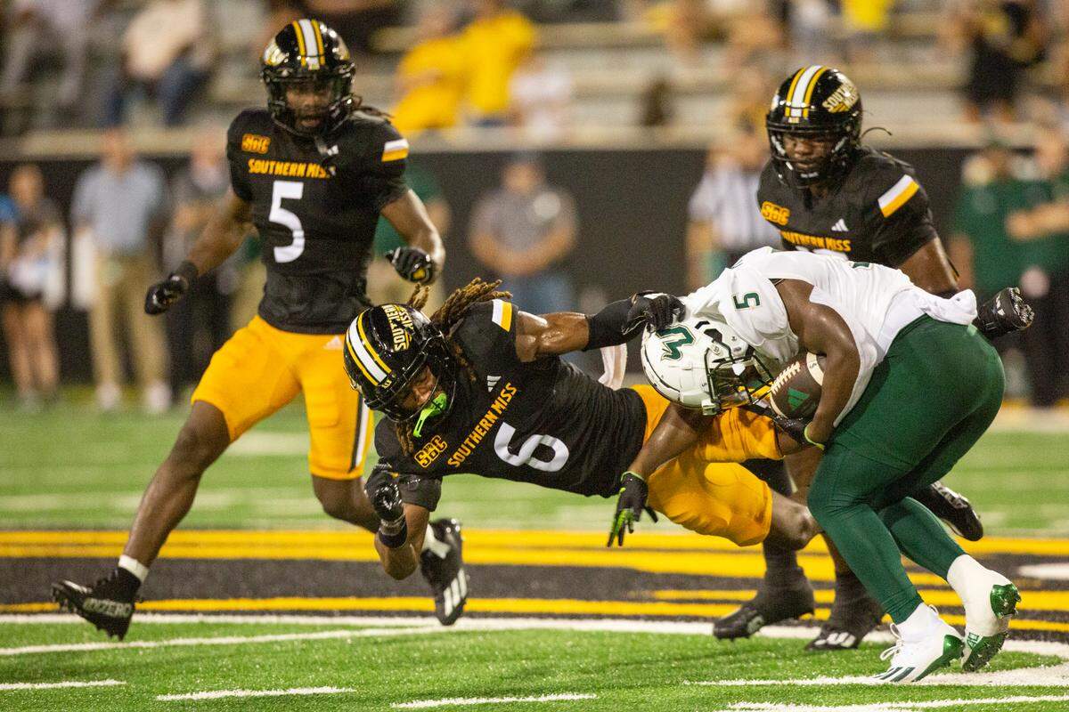 Southern Miss Golden Eagles safety Dylan Lawrence (6) tackles South Florida Bulls running back Nay’Quan Wright (5) during a game between Southern Miss and South Florida at M.M. Roberts Stadium in Hattiesburg on Saturday, Sept. 14, 2024.
