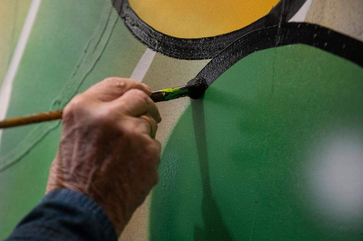 Doug Blom paints the side of a Gulf Coast Carnival Association Mardi Gras float at the float den in Biloxi on Wednesday, Jan. 10, 2024.