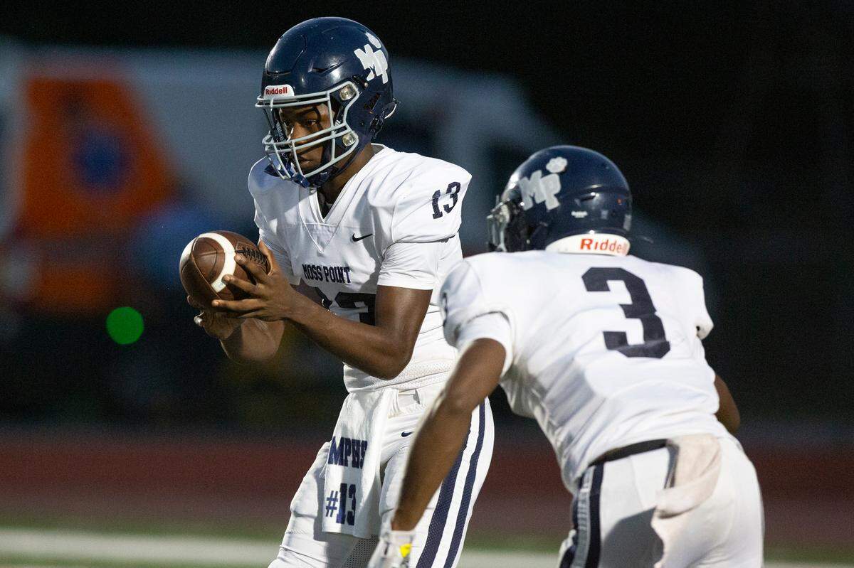 Moss Point’s KeVon Ford passes the ball off to Taboris Charles during a game against West Harrison at West Harrison High School in Gulfport on Friday, Sept. 22, 2023.