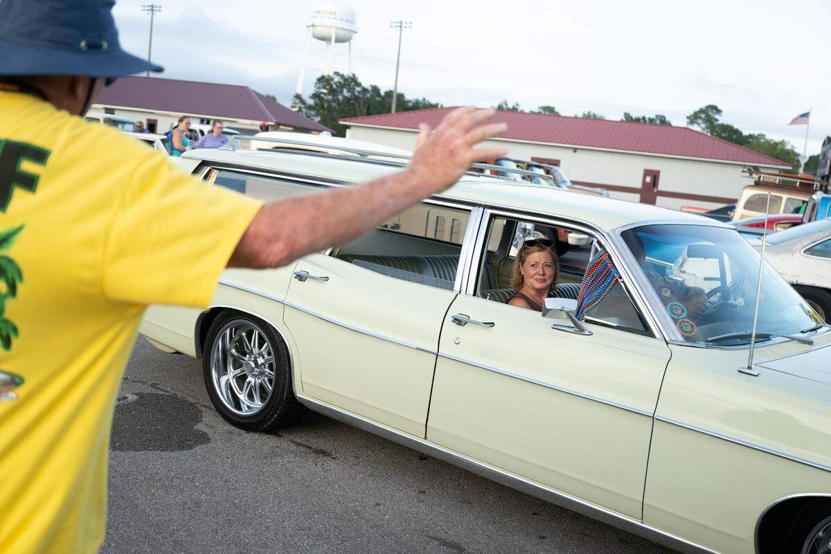 Even attendees wave as vintage cars drive onto North Cleveland Avenue.