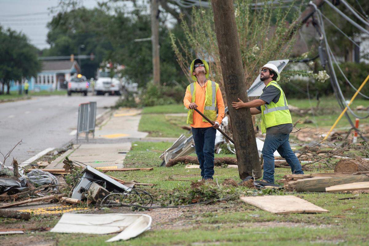 Mississippi Power workers reinstall telephone poles in Moss Point on Tuesday, June 20, 2023, after a tornado tore through the town on Monday, knocking out power to thousands.