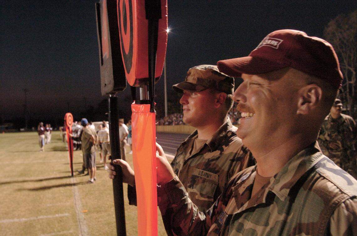 Senior Airman William Powell, right, of the 202nd Combat Engineering Co. and Specialist Joshua Snipes of the 269th Engineering Co. were recruited to help with the chain gang at the Bay St. Louis and Long Beach game on Sept. 26, 2005. The two are among the Florida National Guardsmen who helped Hancock County recover from Hurricane Katrina.