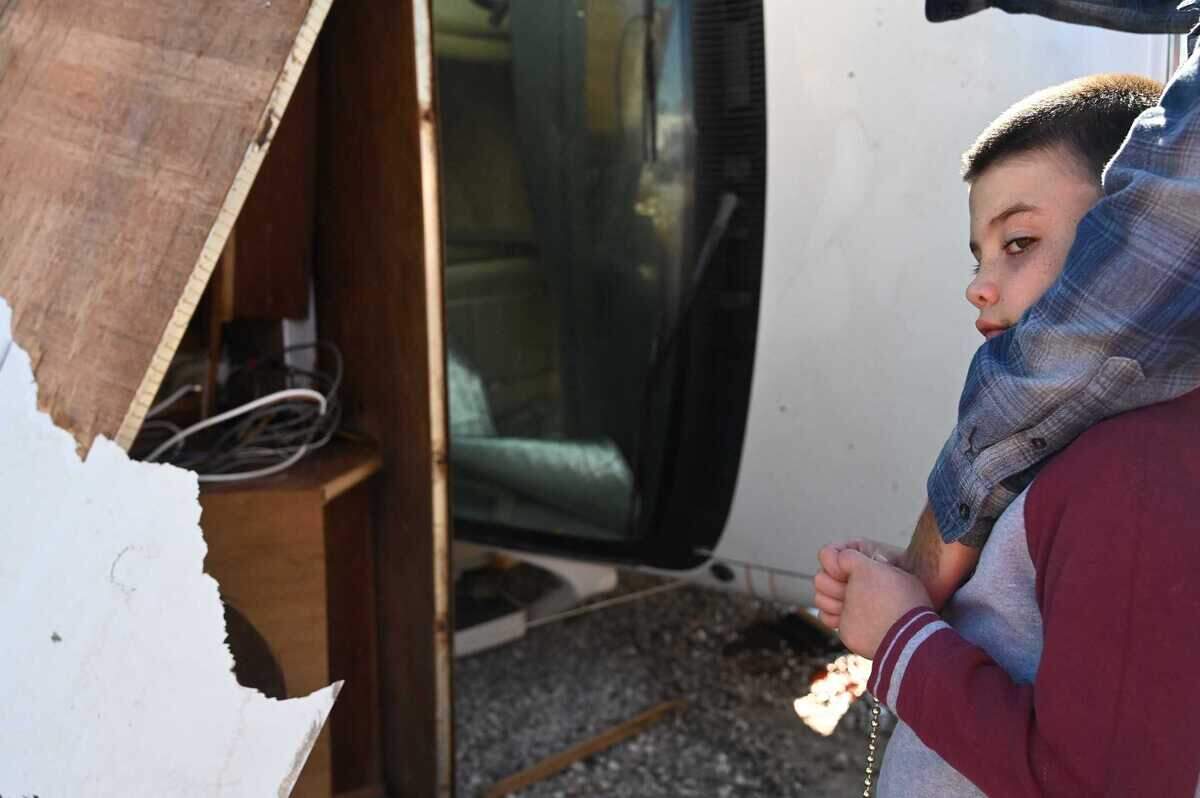 Myles Matos, of Gulfport, examines the damage to mobile homes at the Gulf Haven Campground in Gulfport, Mississippi. His grandfather stayed at the campground during Hurricane Zeta, and the mobile home next to his flipped, giving the woman inside a broken arm.