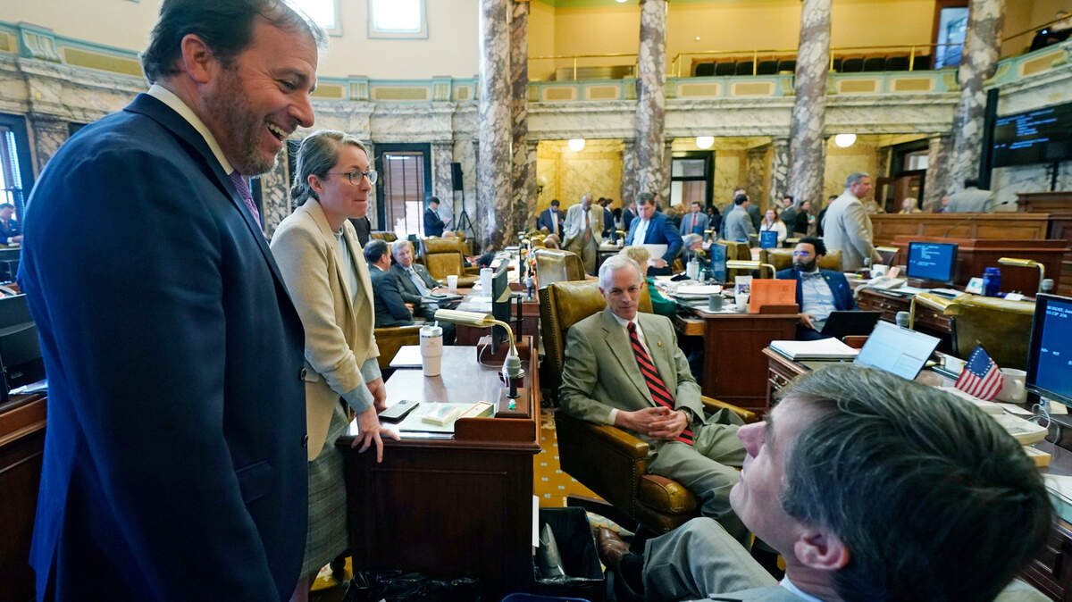 Republican Sens. Josh Harkins of Flowood, left, Jenifer Branning of Philadelphia, second from left, Briggs Hopson of Vicksburg, right, confer with Democratic Sen. David Blount of Jackson, second from right, during the morning session of the Mississippi Senate in Jackson in 2023.