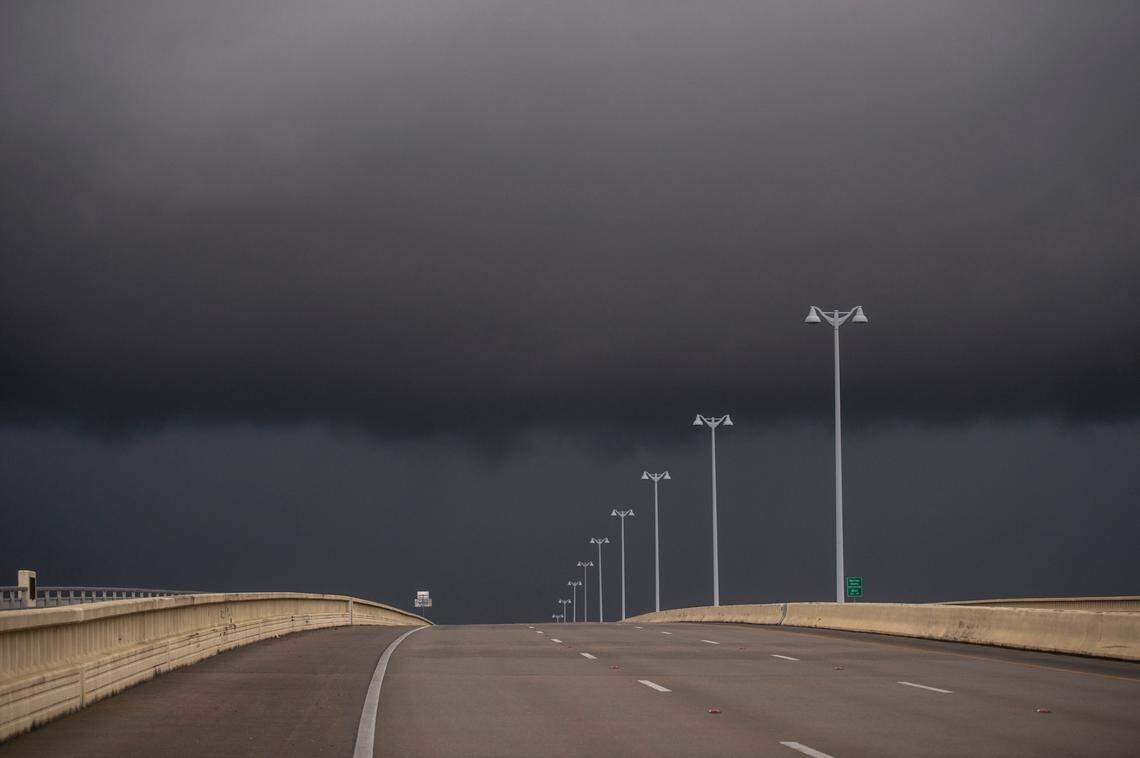 Dark clouds loom over the bridge between Biloxi and Ocean Springs as Hurricane Ida arrives on Sunday.