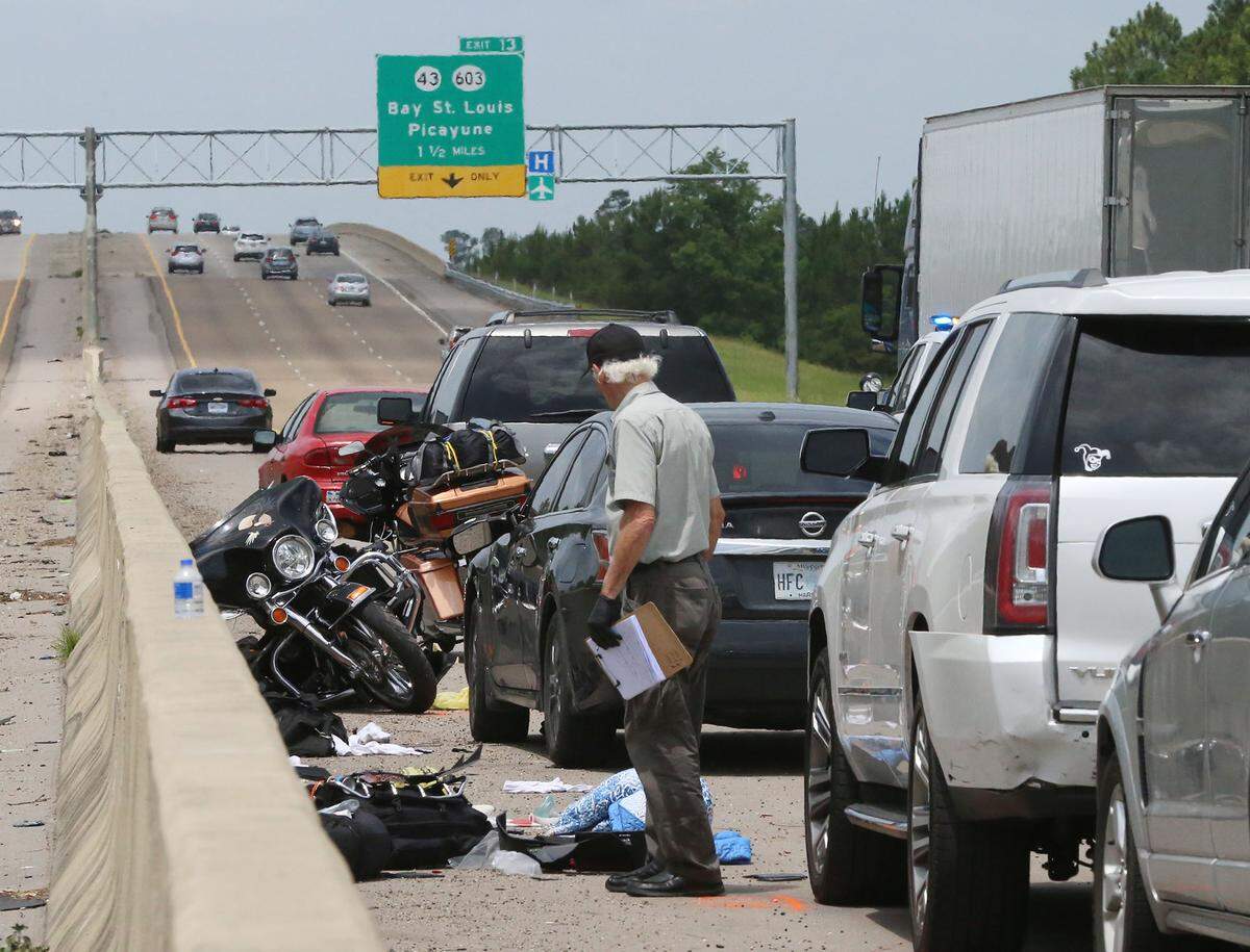 Hancock County Coroner Jim Faulk investigates the scene of a fatal accident on I-10 in Hancock County near Diamondhead on Thursday, June 21, 2018.