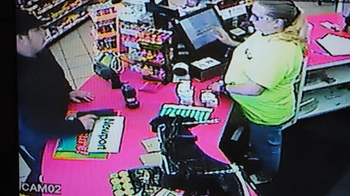 Surveillance footage shows a man brandishing a handgun during an armed robbery at a Bay St. Louis gas station Tuesday morning. (Courtesy of Bay St. Louis PD)
