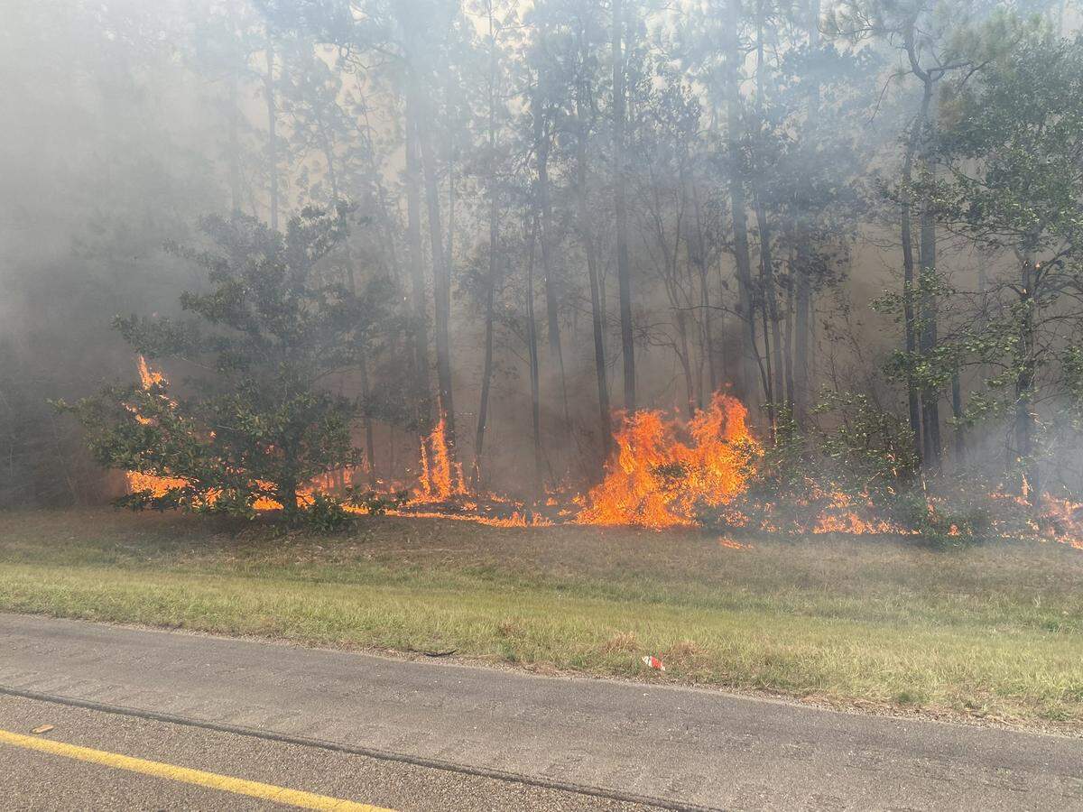 A large grass fire burns at the 2 mile-marker on I-10 in Hancock County on Friday, Aug. 10, 2023. The Interstate has been shut down for safety reasons.