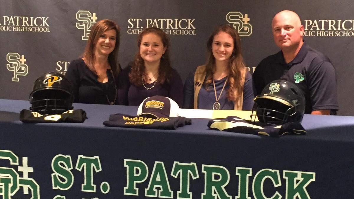 PATRICK OCHS/SUN HERALD 
 Emma Rae Castanedo signed to play softball at Mississippi College on Monday during a ceremony at St. Patrick. Pictured with Castanedo are her mother, Stephanie, her youngest sister, Anna Grace, and her father and coach, Tommy.