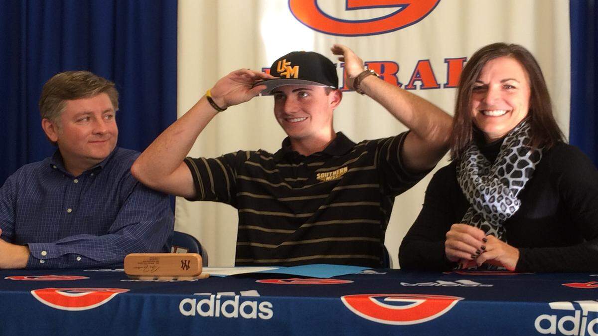 PATRICK MAGEE/SUN HERALD 
Gulfport senior pitcher Alex Nelms, center, signed a letter of intent to play baseball at Southern Miss on Wednesday at Bert Jenkins Gymnasium in Gulfport. Seated next to Nelms are his father, Johnny, and mother, Kathi.