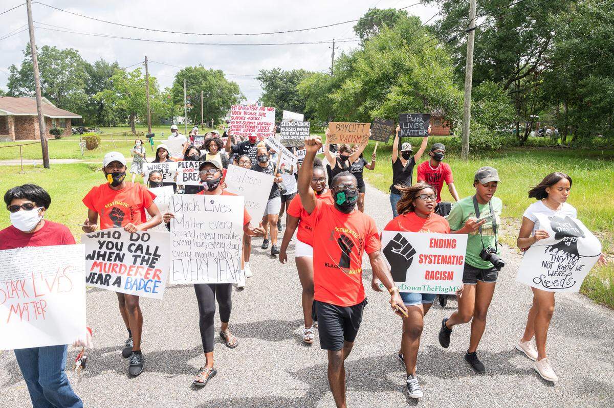 Bobby Hudson and Ella Holmes-Hines lead a march, which was brought together by local college organizers, down Alabama Avenue in Gulfport on Saturday, June 27th, 2020. The protest broadly spoke on systematic racism, law enforcement, and elected officials, but the main focus was on U.S. Representative Steven Palazzo, who protesters say has not representing or listening their community.