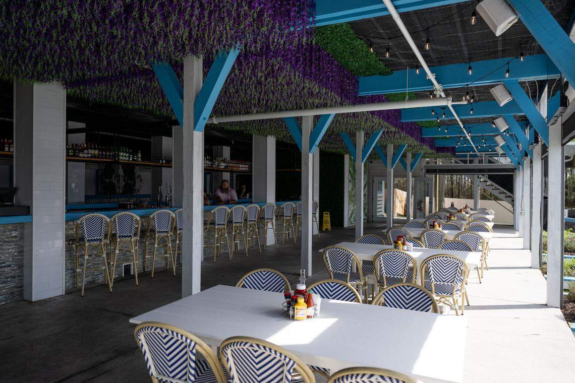The outdoor dining area and bar at Bacchus on the Bluff in Gulfport are at the edge of the bayou, where customers can arrive by boat.