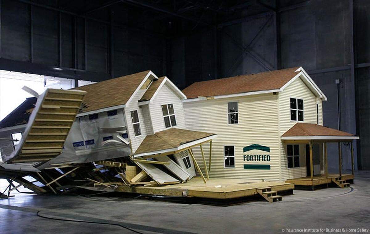 The Insurance Institute for Business & Home Safety has for decades tested construction materials and developed standards for building to withstand severe weather, including hurricanes. Its research center in South Carolina can replicate hurricane-force winds of up to 130 miles per hour. The test pictured here shows how standard construction collapses in high winds, while a FORTIFIED (IBHS trademark) home stands up to the pressure.