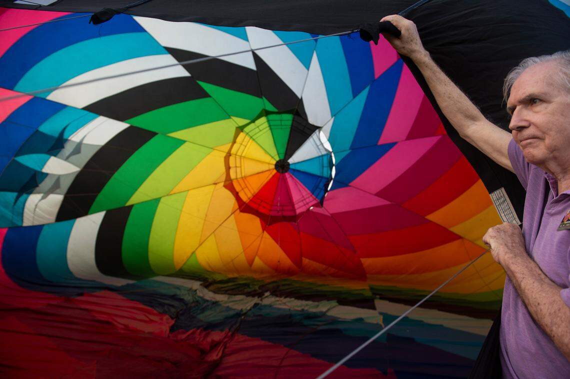 A crew member helps get a hot air balloon up during the Gulf Coast Hot Air Balloon Festival at OWA in Foley, Alabama on Thursday, May 4, 2023.