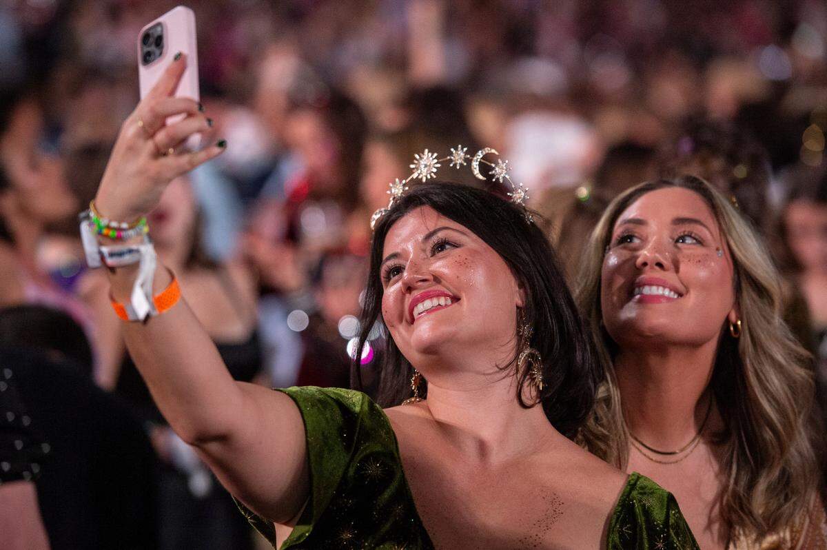 Fans take selfies before the start of Taylor Swift’s The Eras Tour at the Cesars Superdome in New Orleans on Friday, Oct. 25, 2024.