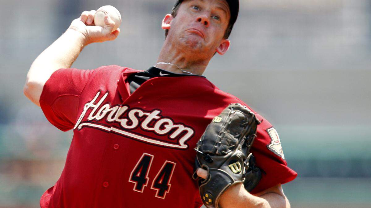 FILE - In this July 18, 2010 file photo, Houston Astros pitcher Roy Oswalt throws in the first inning during a baseball game against the Pittsburgh Pirates in Pittsburgh. A person with knowledge of the deal says Houston ace Roy Oswalt has agreed to waive his no-trade clause and accept a swap to the Philadelphia Phillies on Thursday, July 29, 2010. (AP Photo/Gene J. Puskar, File)