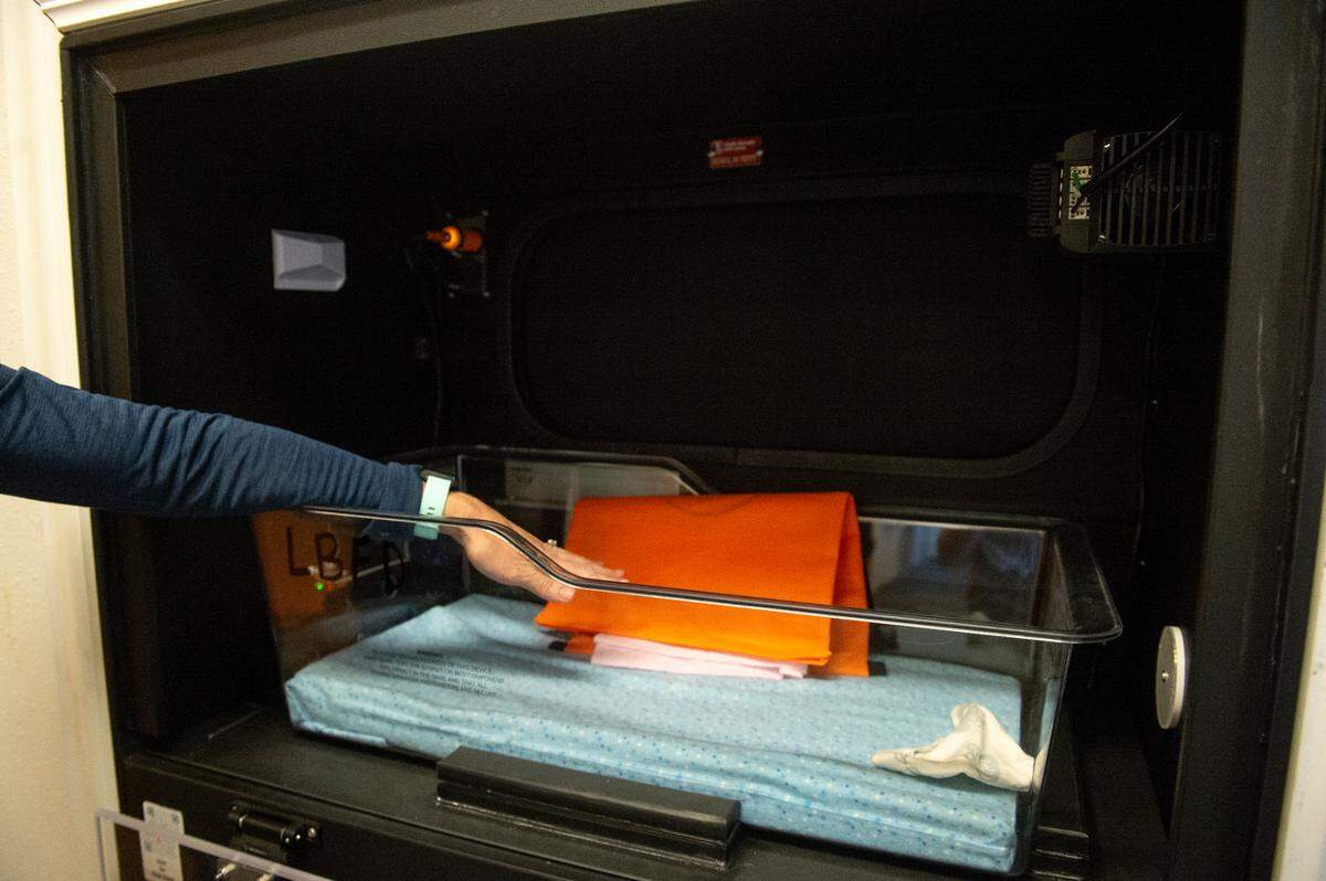 Caitlin Kelly shows off the Safe Haven Baby Box, a box that allows mothers to surrender their newborns anonymously, at the Long Beach Fire Department in Long Beach on Thursday, June 20, 2024. So far Long Beach’s baby box, which was the first in Mississippi, has not been used.