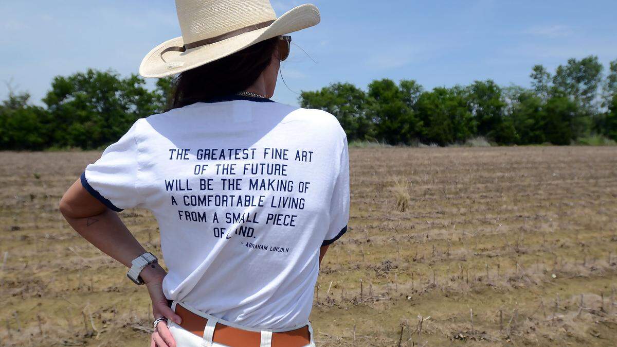 Lauren Swann of New Albany, looks out at the Red Hill Bottom acreage in the Fairfield Community where she and her husband Rhett grow cotton and are hoping for no more rain, Thursday, May 15, 2025. Heavy rains have made the fields too muddy for farming equipment, delaying planting.