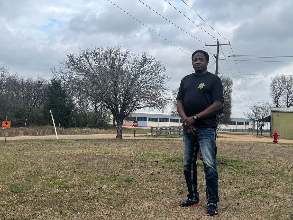 Madison County Constable Johnny Sims stands outside his home down the road from Amazon’s data center campus in Canton. He blames construction dust from the unfinished facility for worsening his teenage daughter’s asthma symptoms.