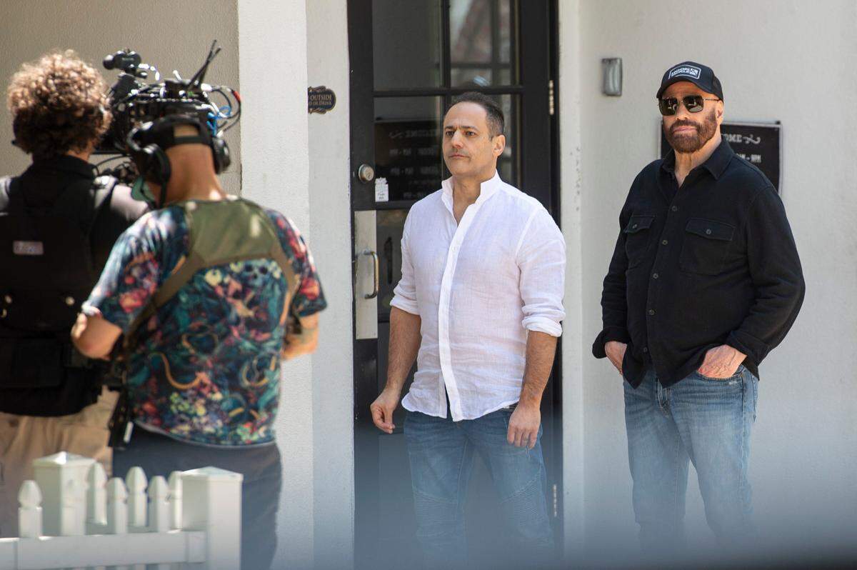 Actor John Travolta, right, and another cast member on the set of Cash Out 3 during filming in Ocean Springs on April 8, 2025.