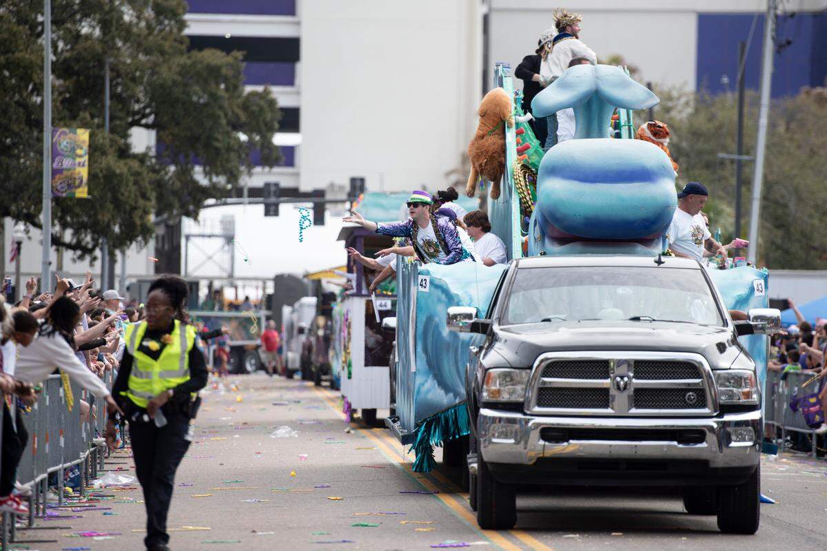 Float riders throw beads to the crowd during the Gulf Coast Carnival Association Mardi Gras parade in Biloxi on Tuesday, March 4, 2025.
