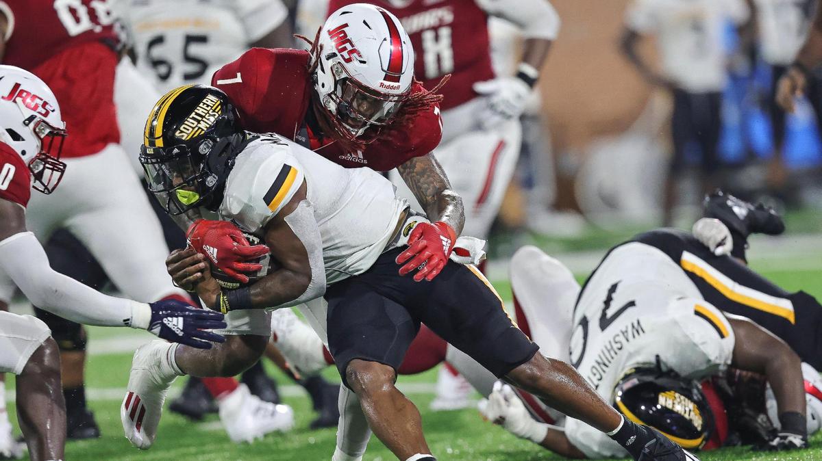 Southern Miss Golden Eagles running back Darius Maberry (7) is tackled by South Alabama Jaguars linebacker Chris Henderson (7) during the game between Southern Miss and South Alabama at Hancock Whitney Stadium, Mobile, Alabama, September 4, 2021.