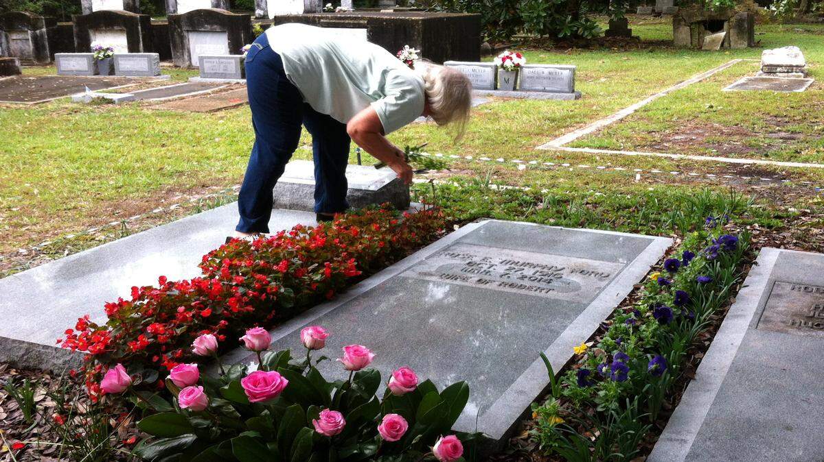 TAMMY SMITH/SUN HERALDTwila Ford snips some lemon verbena to give members of the Moss Point Garden Club during a recent presentation at Greenwood Cemetery in Pascagoula. Ford says vases can be breeding grounds for mosquitoes.