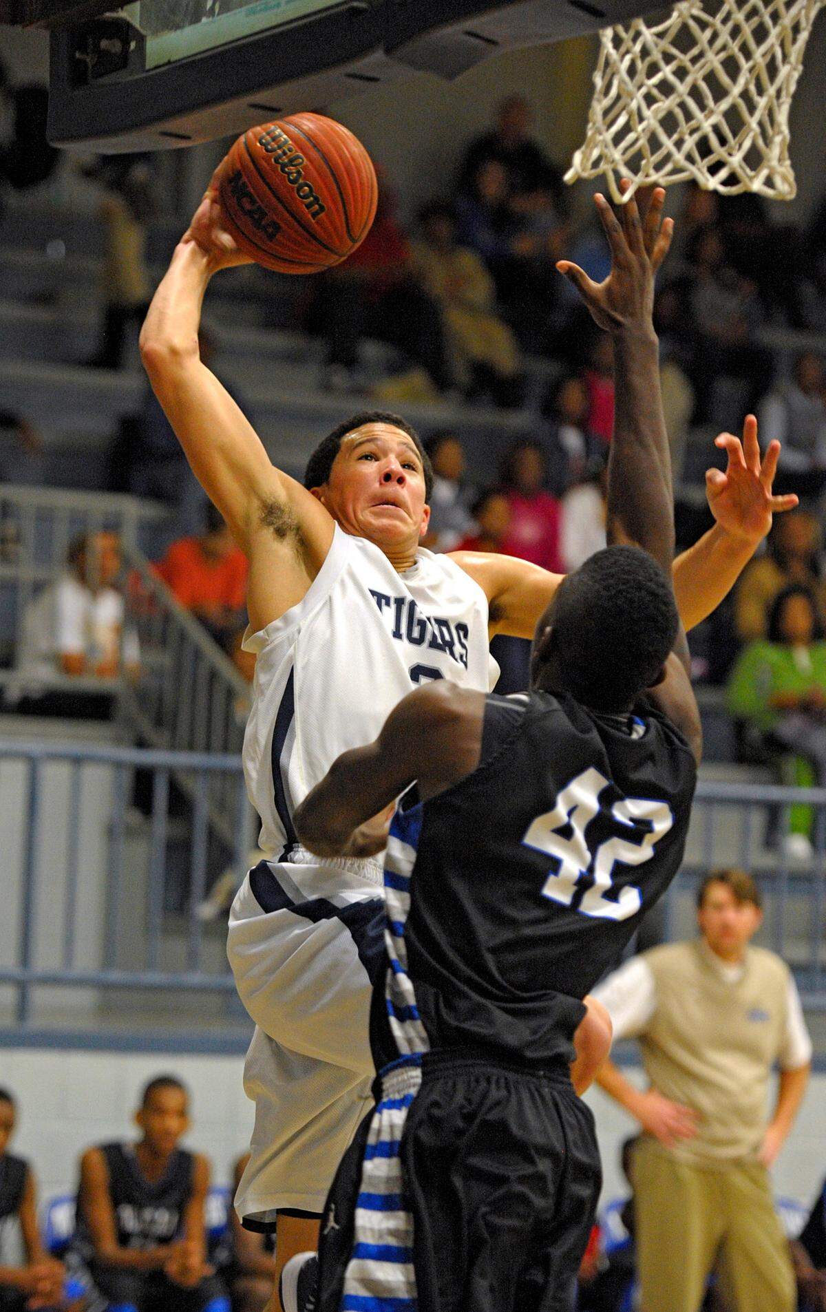 Moss Point’s Devin Booker goes up for a dunk attempt over Ocean Springs forward Clyde Blackston (42) on Dec. 4, 2012 in Moss Point.