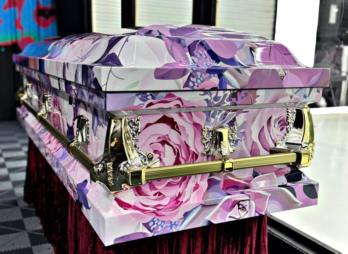 A garden of pink and purple flowers creates a tribute to the life of a young Gulfport victim of the New Year’s Day terrorist attack. The casket wrap was made by a Gulfport man who did the first wrap three years ago after his sister died.