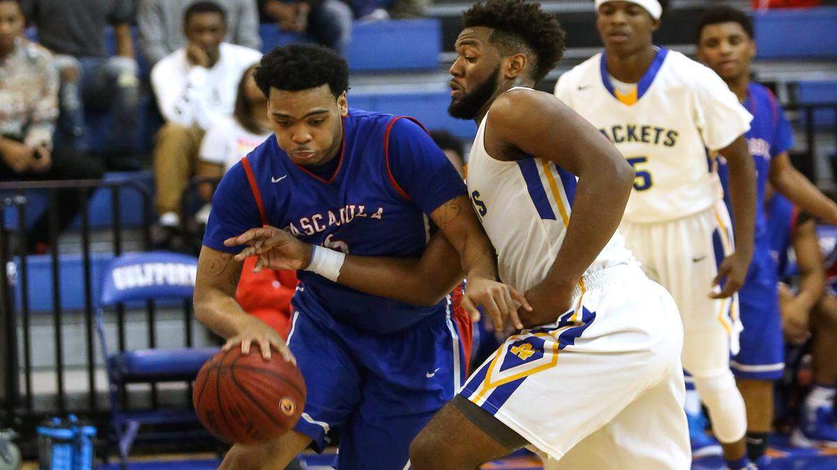 AMANDA McCOY/SUN HERALD 
 Pascaougla's Jacques Belford attempts to dribble past St. Martin's Jonte Moultrie to the basket during the Gulfport Hardwood Holiday Classic on Monday, December 28, 2015. Pascagoula defeated St. Martin in overtime, 71-70.