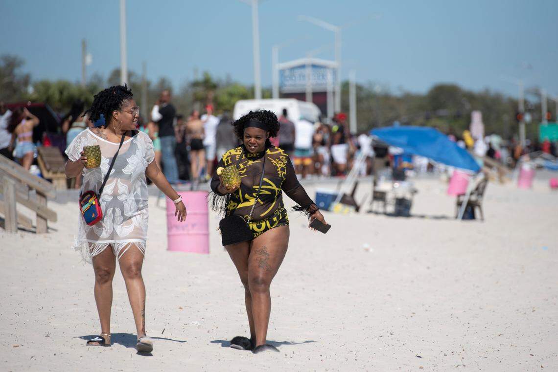Spring breakers walk along Biloxi Beach during Black Spring Break in Biloxi on Saturday, April 9, 2022.