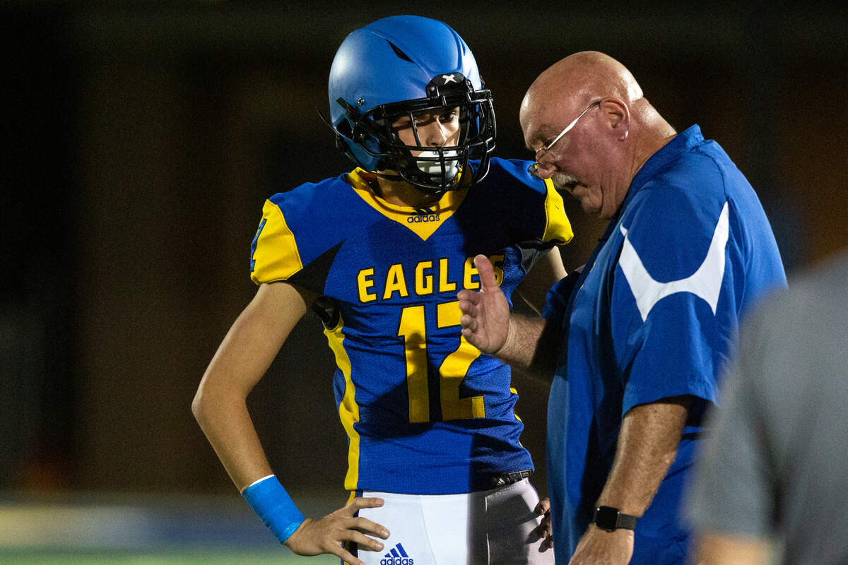 Resurrection Head Coach Eric Denmark talks to kicker Iain Cumbest during a game against Richton at Gautier High School in Gautier on Friday, Oct. 14, 2022.
