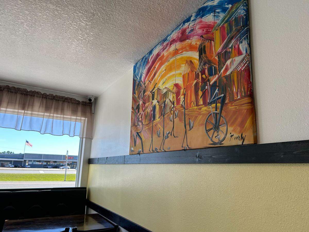 Caribbean style art lines the interior of El Punto Familiar Restaurant in Pascagoula, Mississippi.