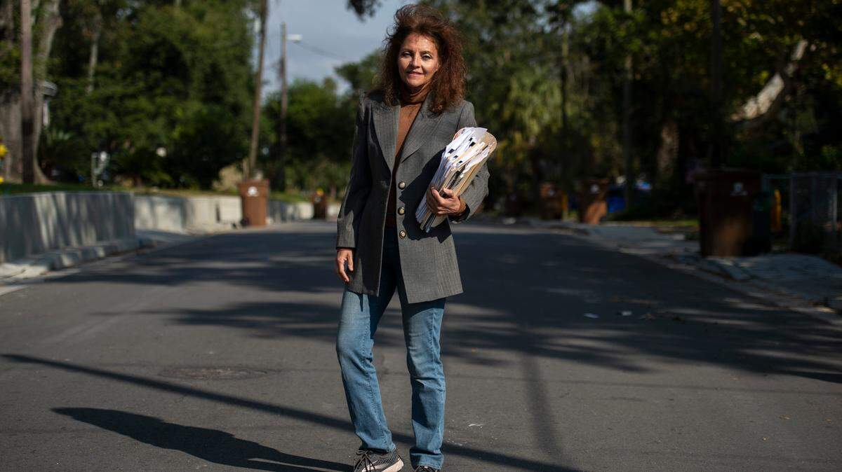 Lela Jordan stands in the middle of Benachi Avenue in Biloxi with a stack of paperwork she’s been accumulating on the Biloxi public works project on Friday, Nov. 5, 2021. Since moving back to Biloxi from Florida, Jordan has been pushing the city of Biloxi fix driveways and sidewalks that were improperly installed.
