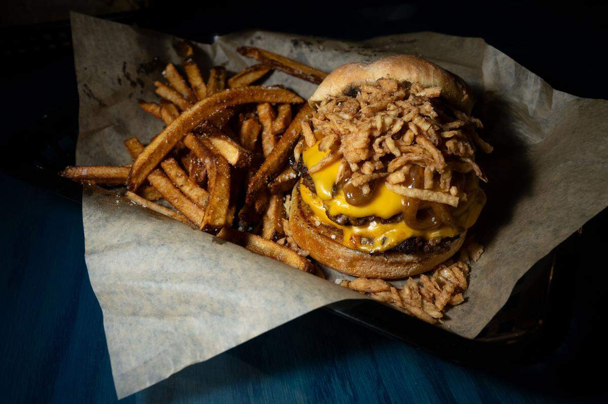 The onion smash burger with hand cut fries at Boonies on the Bayou on Friday, Dec. 5, 2025.