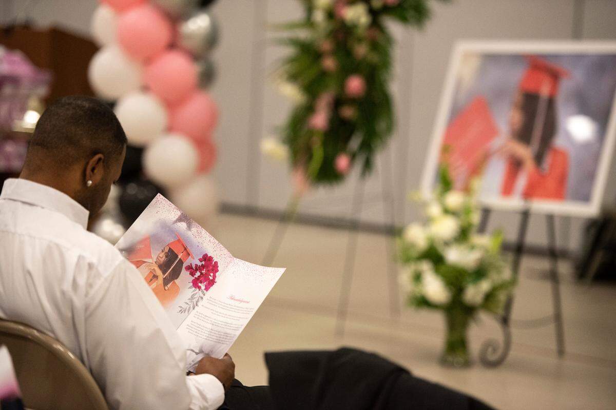 A mourner reads the program during the funeral of Ni’Kyra Dedeaux at Lyman Community Center in Gulfport on Friday, Jan. 10, 2025. Dedeaux was killed in an alleged terrorist attack on Bourbon Street in New Orleans on Jan. 1.