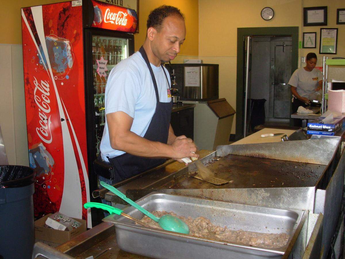 Tony Nelson works at the grill at his restaurant, Tony Nelson’s King of Philly Cheese Steaks, on Pass Road in Gulfport in this 2011 file photo.